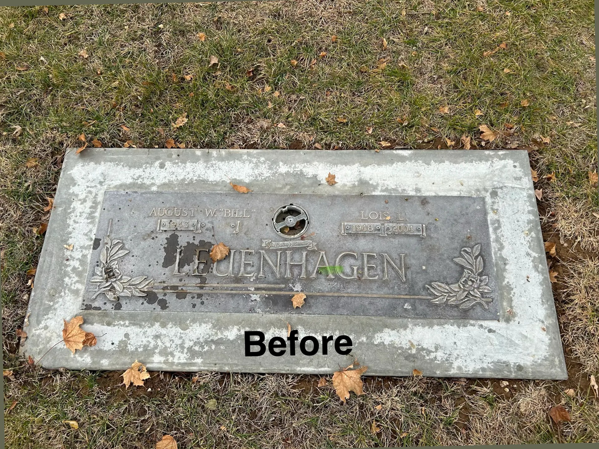 Weathered bronze flat marker before cleaning